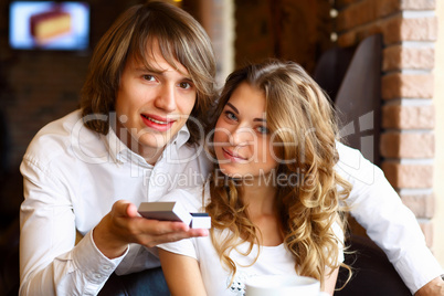 Young couple with engagement ring in a restaurant