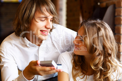 Young couple with engagement ring in a restaurant