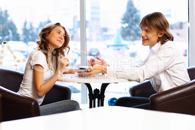 Young couple with engagement ring in a restaurant