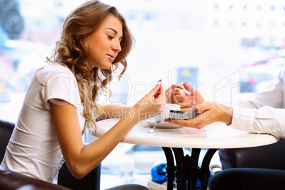 Young couple with engagement ring in a restaurant