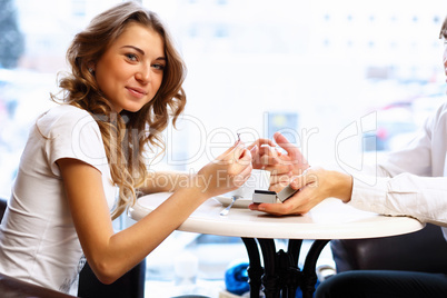 Young couple with engagement ring in a restaurant