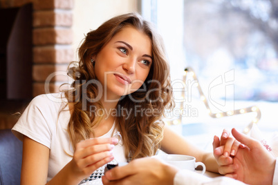 Young couple with engagement ring in a restaurant