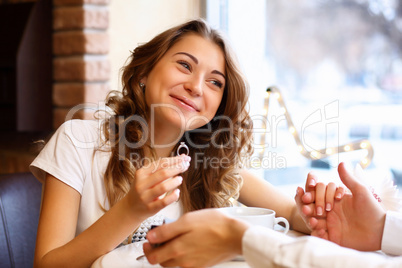 Young couple with engagement ring in a restaurant