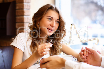 Young couple with engagement ring in a restaurant