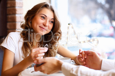 Young couple with engagement ring in a restaurant