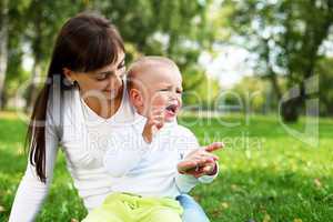 Young mother with her son in summer park