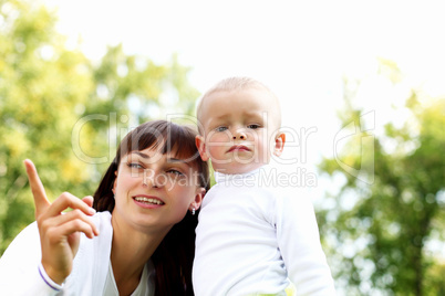 Young mother with her son in summer park