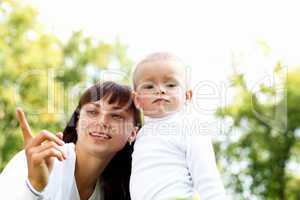 Young mother with her son in summer park