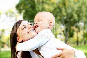 Young mother with her son in summer park