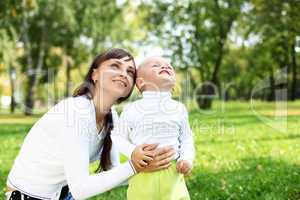 Young mother with her son in summer park