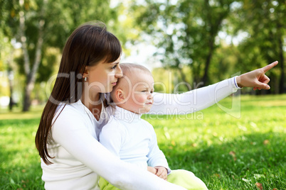 Young mother with her son in summer park