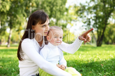 Young mother with her son in summer park