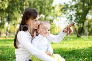 Young mother with her son in summer park