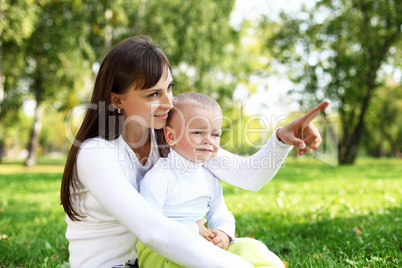 Young mother with her son in summer park