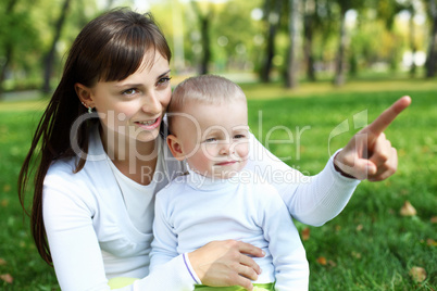 Young mother with her son in summer park