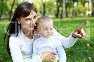 Young mother with her son in summer park