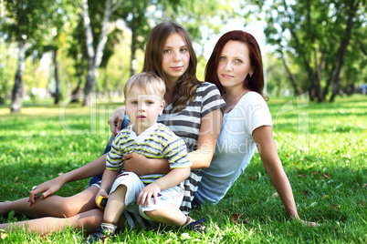 Young mother with her son in summer park