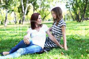 Mother with her daughter in summer park