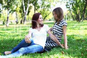 Mother with her daughter in summer park