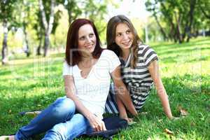 Mother with her daughter in summer park