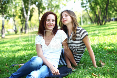 Mother with her daughter in summer park