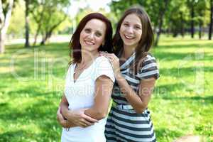 Mother with her daughter in summer park