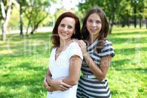 Mother with her daughter in summer park