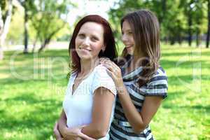 Mother with her daughter in summer park