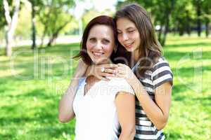 Mother with her daughter in summer park