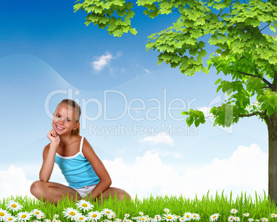 Smiling girl on green grass