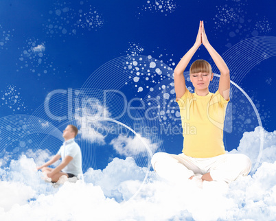 Young woman doing yoga against blue sky