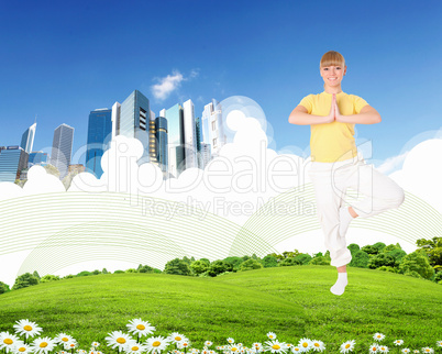 Young woman doing yoga against blue sky