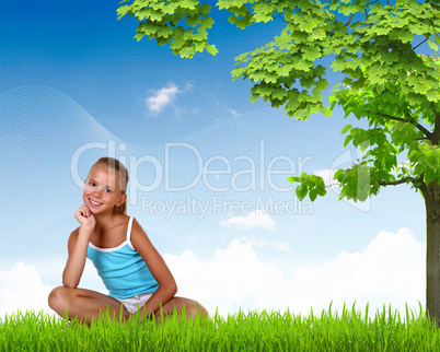 Smiling girl on green grass