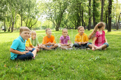 Group of children sitting together in the park