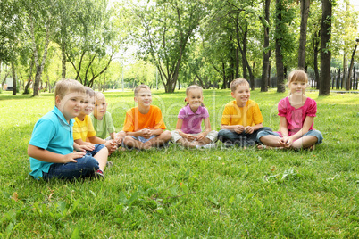 Group of children sitting together in the park