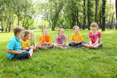 Group of children sitting together in the park