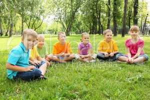 Group of children sitting together in the park