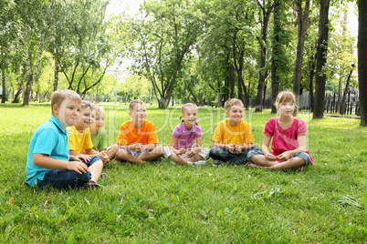 Group of children sitting together in the park