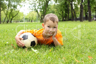 Little boy in the park with a ball