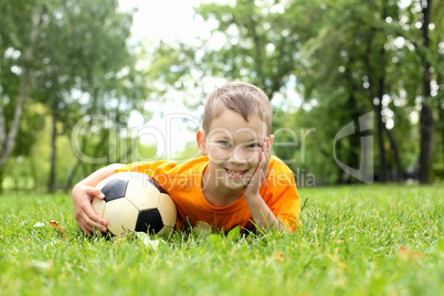 Little boy in the park with a ball