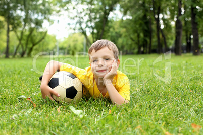 Little boy in the park with a ball