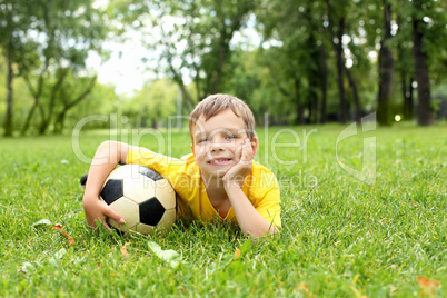 Little boy in the park with a ball