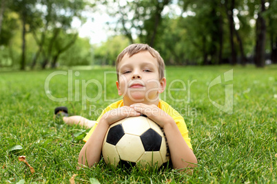 Little boy in the park with a ball