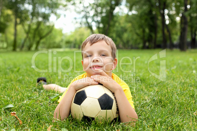 Little boy in the park with a ball