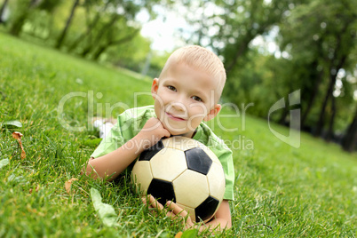 Little boy in the park with a ball