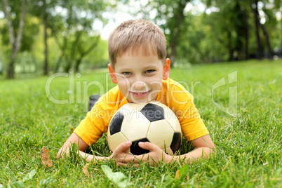 Little boy in the park with a ball