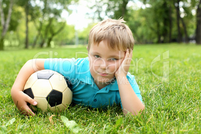 Little boy in the park with a ball