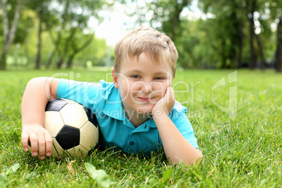 Little boy in the park with a ball