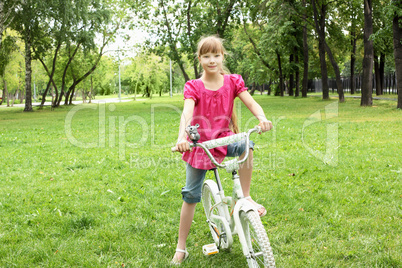 Girl with a bike in the park