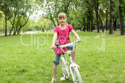 Girl with a bike in the park